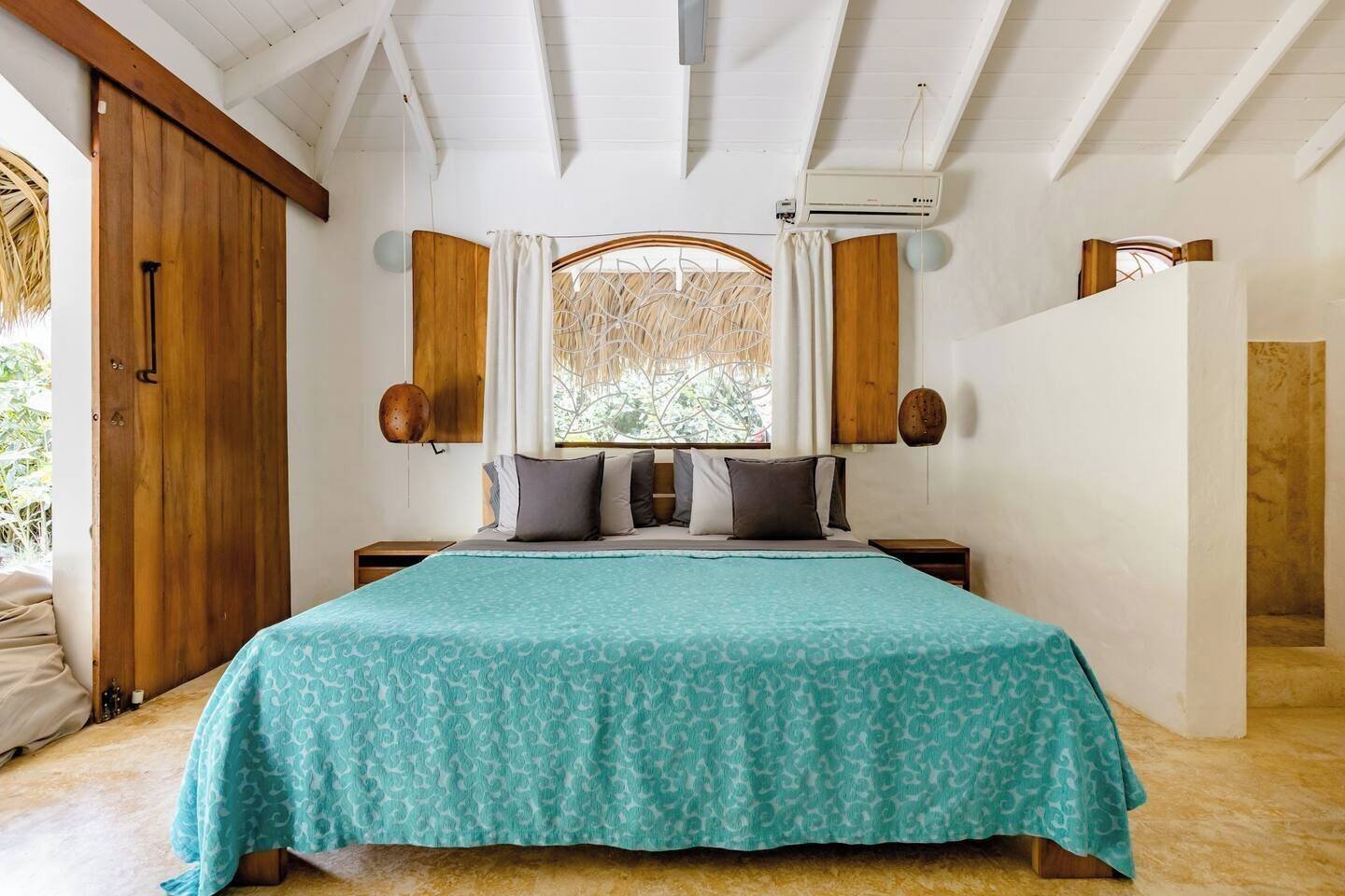 Casa Picaflor: Comfort room with a wooden headboard and air conditioning